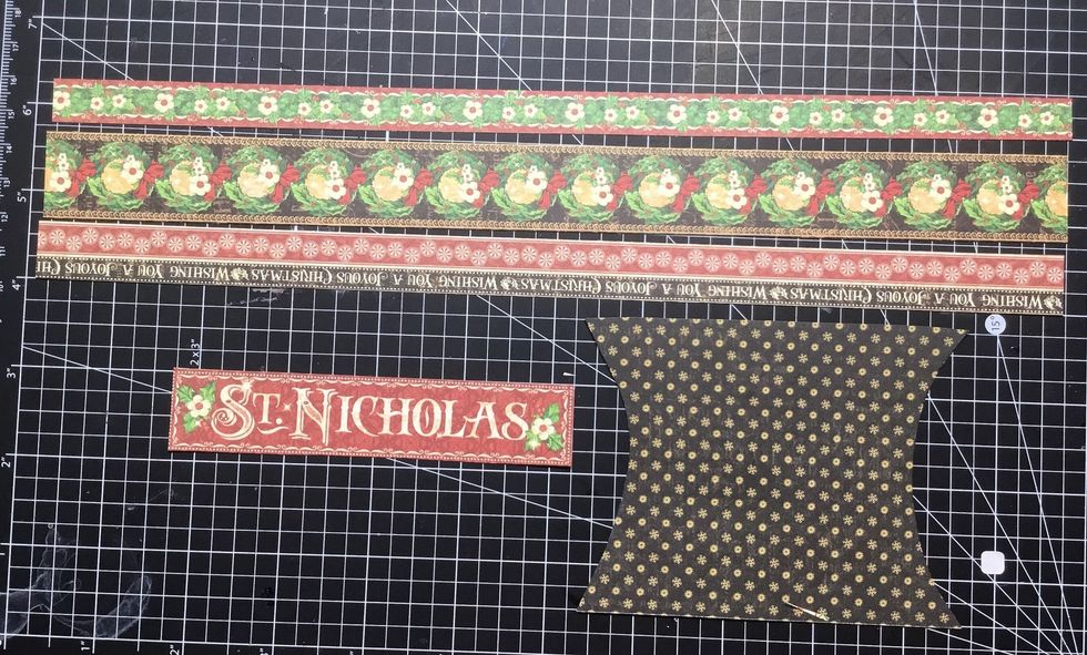 Locate these paper strips from the papers. Use the pillow box pattern to cut a piece of paper that will fit onto the front of the box.