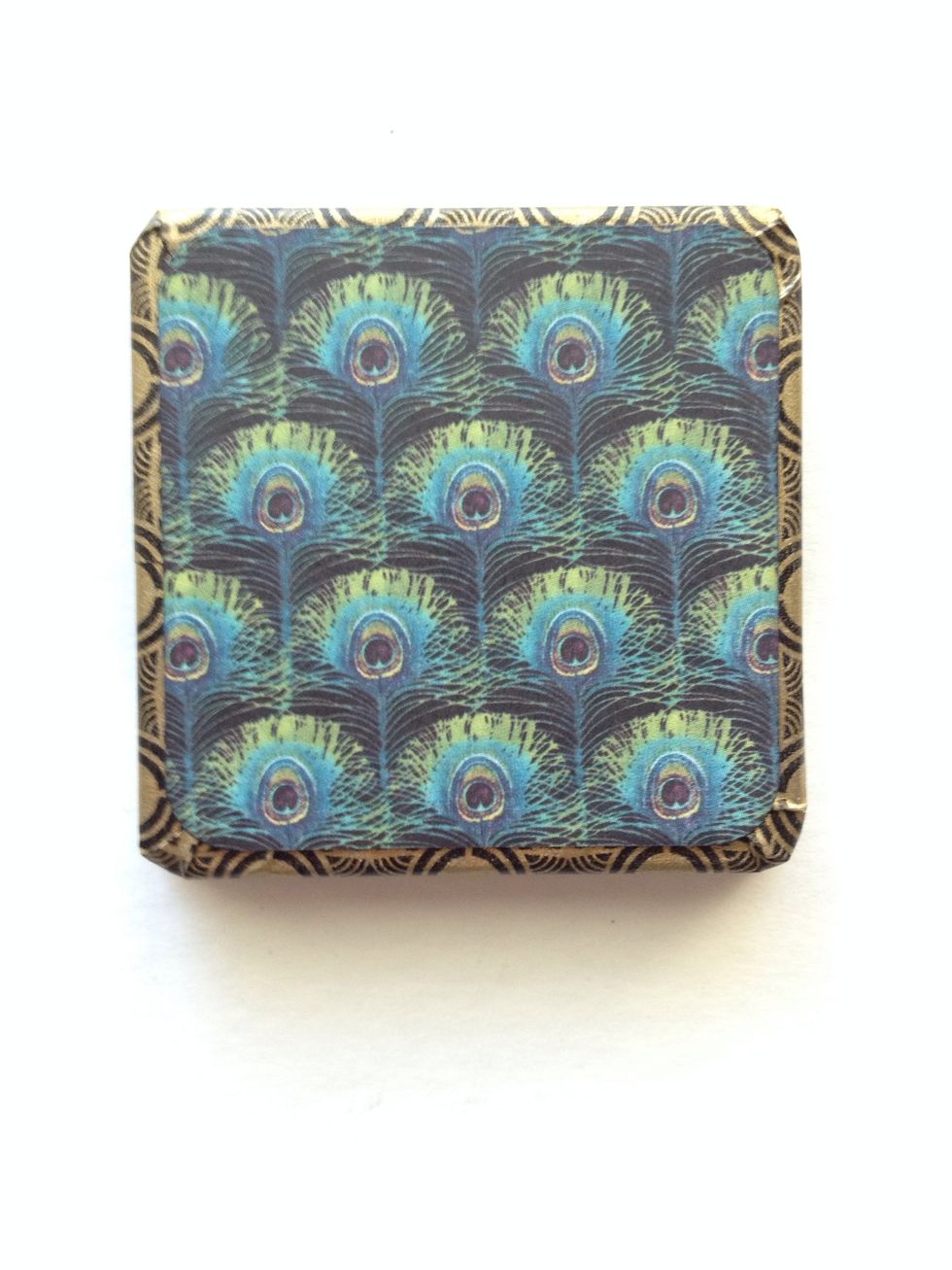 Locate your 8x8 paper pad. Find the Stunning paper with peacock feathers. Cut (2) 2 1/4" squares and round the edges. Adhere one square to the top of your lid.