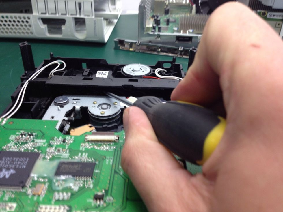 Locate your flathead screwdriver against a ridge and push it to the side. Do not use a lot of force. Movement will be minimal. You will notice the grey metal move up toward you hand. At this point...