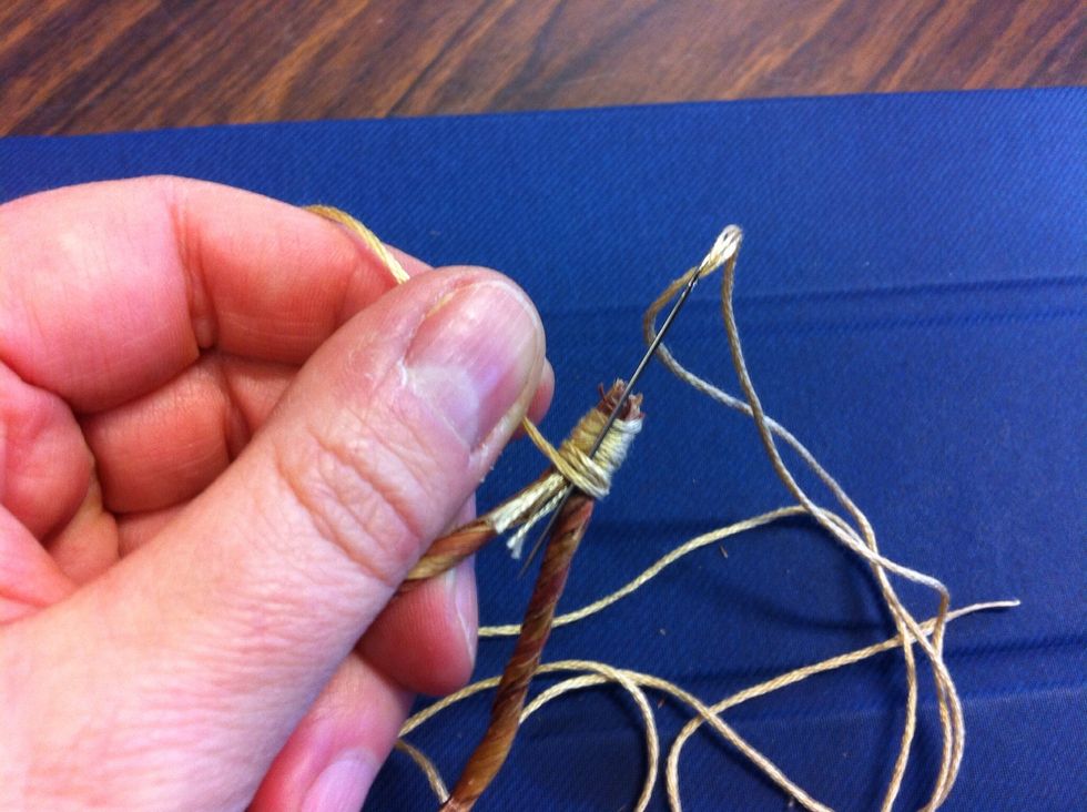 Lock the thread in place by running your needle through the wrapped thread and pulling the thread all the way through.