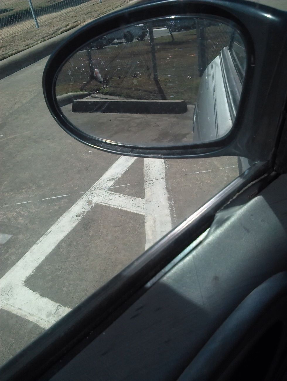 Look through the side mirror and try to get between the lines.