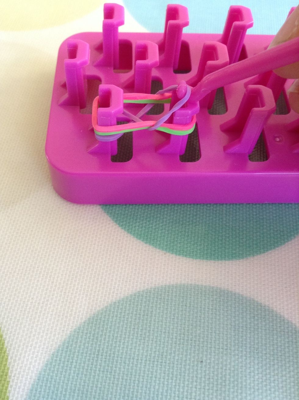 Loop it over the top of the other two.