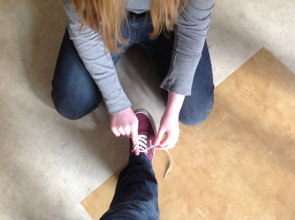 Loop one of the laces around your finger while keeping the other one tight.