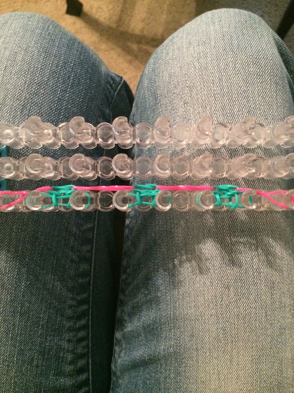 Loop over the bottom row of blue bands again. It will look like this. Push the bands down.