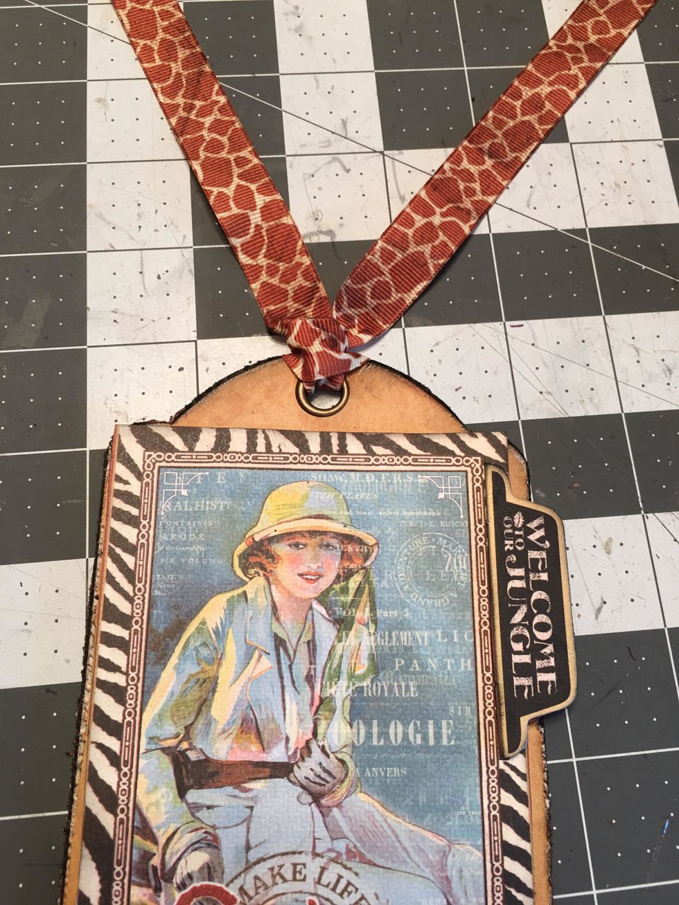 Loop ribbon through the tag. You will do this for each finished tag of your album. The ribbons are attached to each tag rather than through the ring.