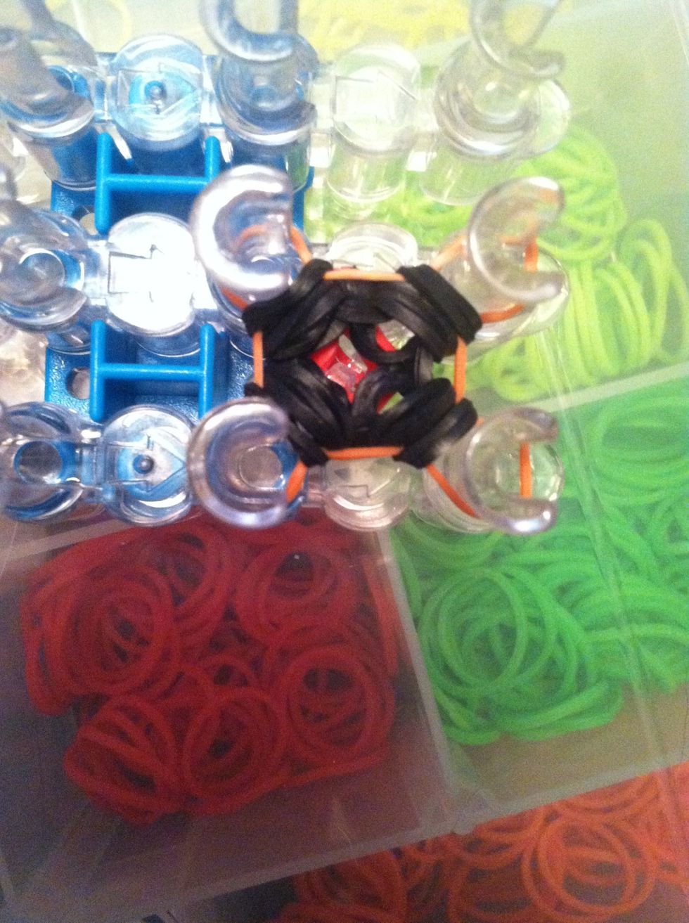 Loop the black bands over the orange