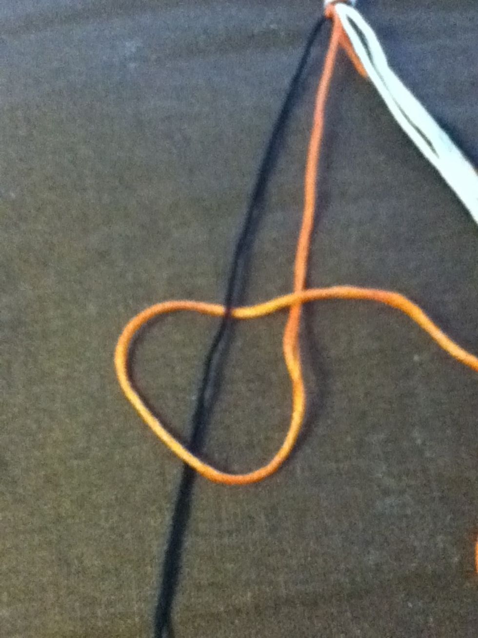 Loop the border thread around the second thread and back over itself. This is called a reverse knot.