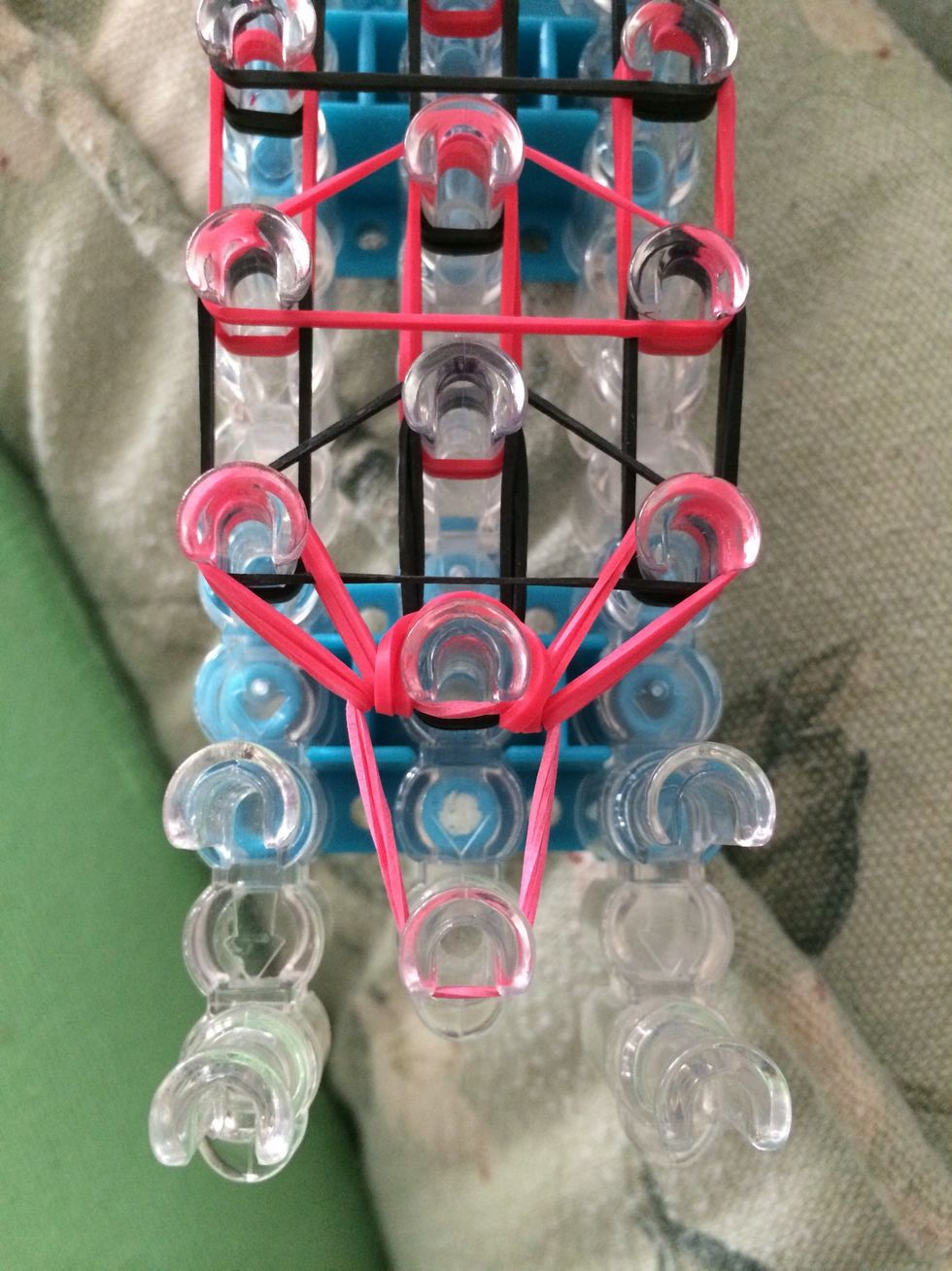 Loop the bottom red rubber bands. The middle red rubber band is going to be a little loose but that is okay.