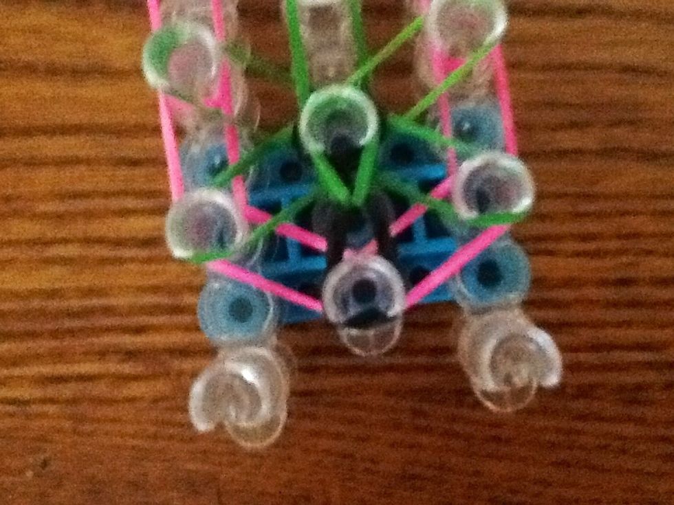 Loop the first band like this and go anti- clockwise.