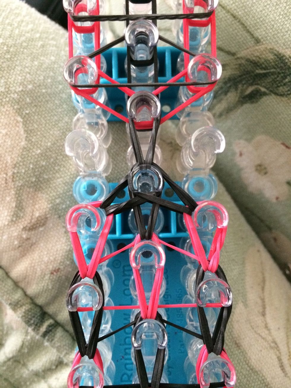 Loop the last two black bands and the middle one