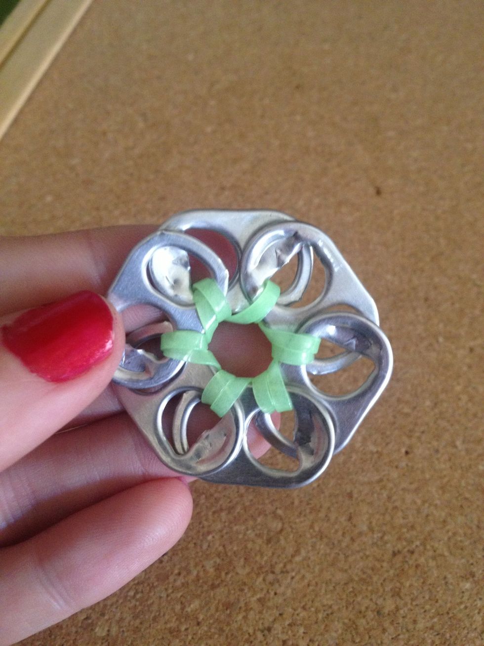 Loop the material through the last holes to context the flower together.