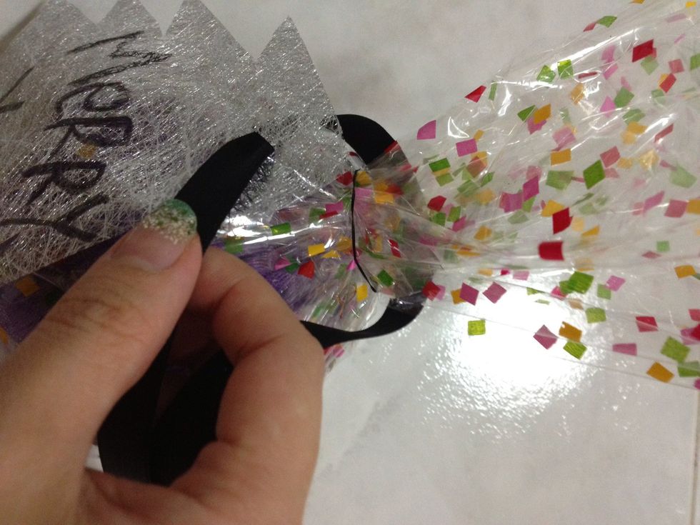 Loop the ribbon through the hole and tie it onto the gift