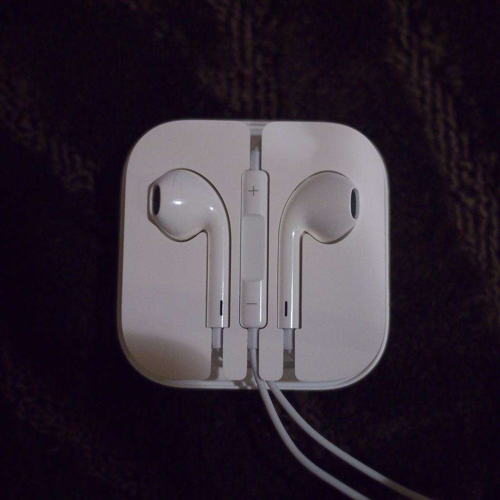 Loop the right ear cable counter clockwise and the remote should rest exactly in the middle slot