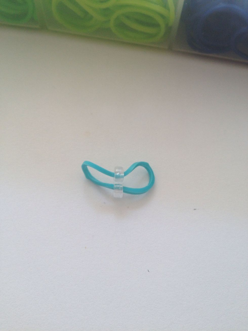 Loop the starting color into the C clip. You can use the colors in the braclett or a white or black rubber band.