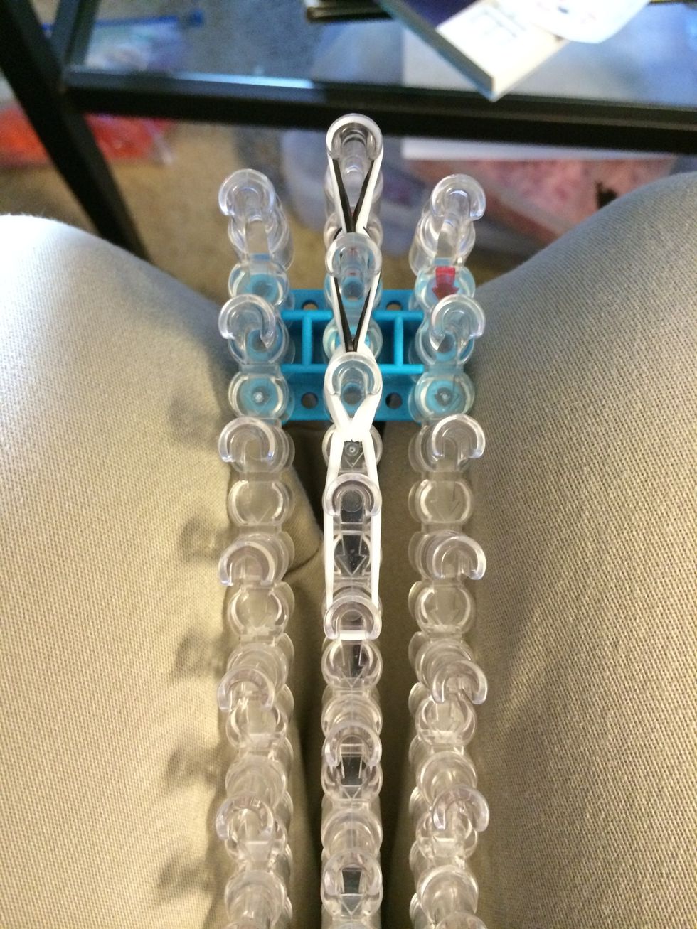 Loop them forward and count our up the row. Not looping the last set of white bands is going to leave us with a fluffy tail.