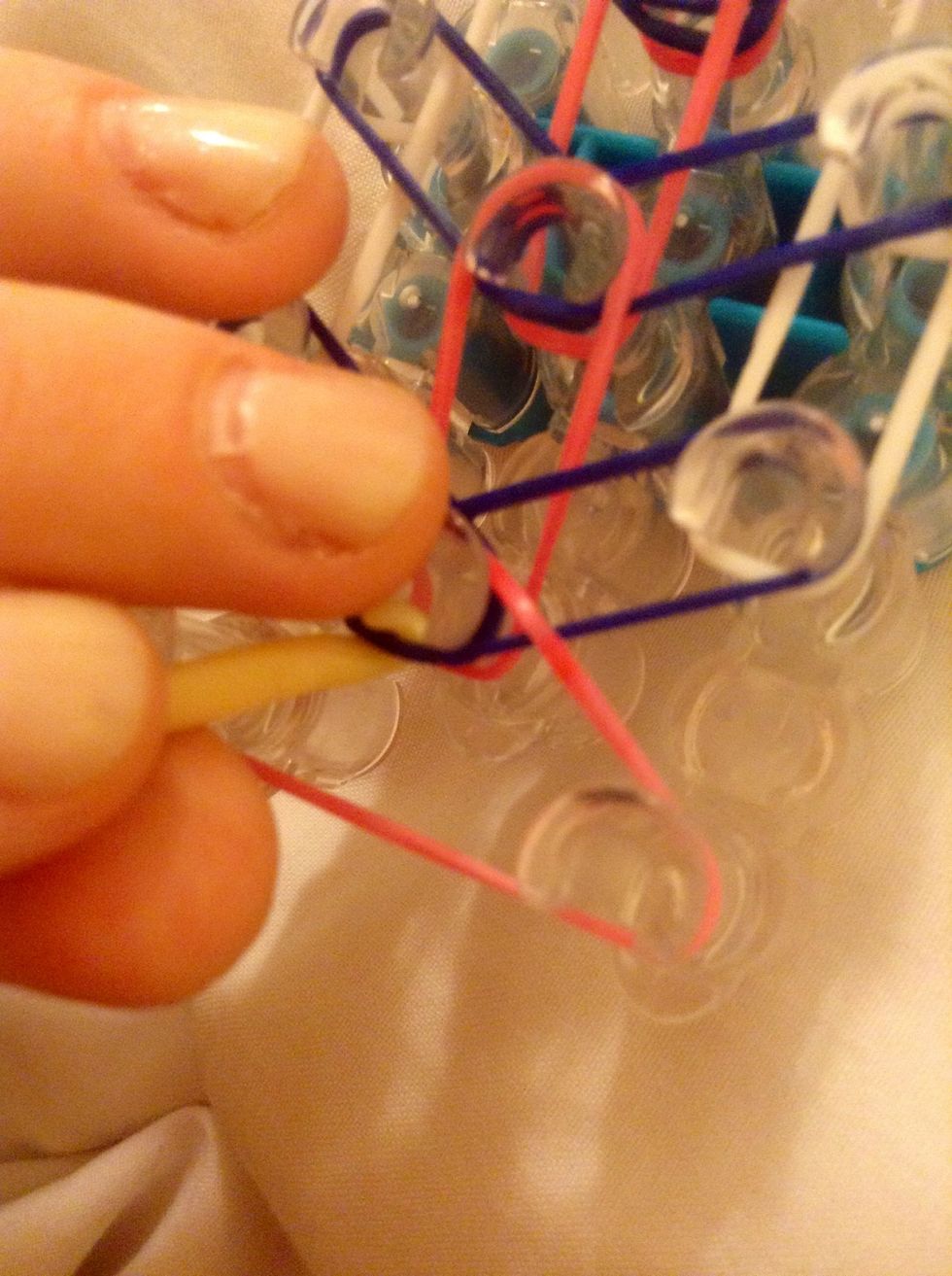 LOOPING- Start For The Bottom And Take The First Blue Band And Put It Over Its Peg!