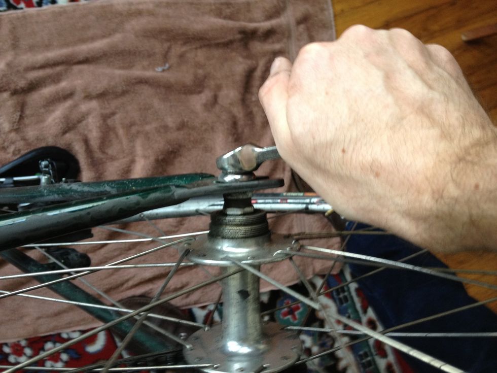 Loosen both bolts (or skewer) on the rear wheel and remove the rear wheel from the bike.