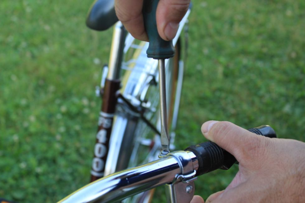 Loosen brake lever and shifter (if necessary) and slide towards stem.