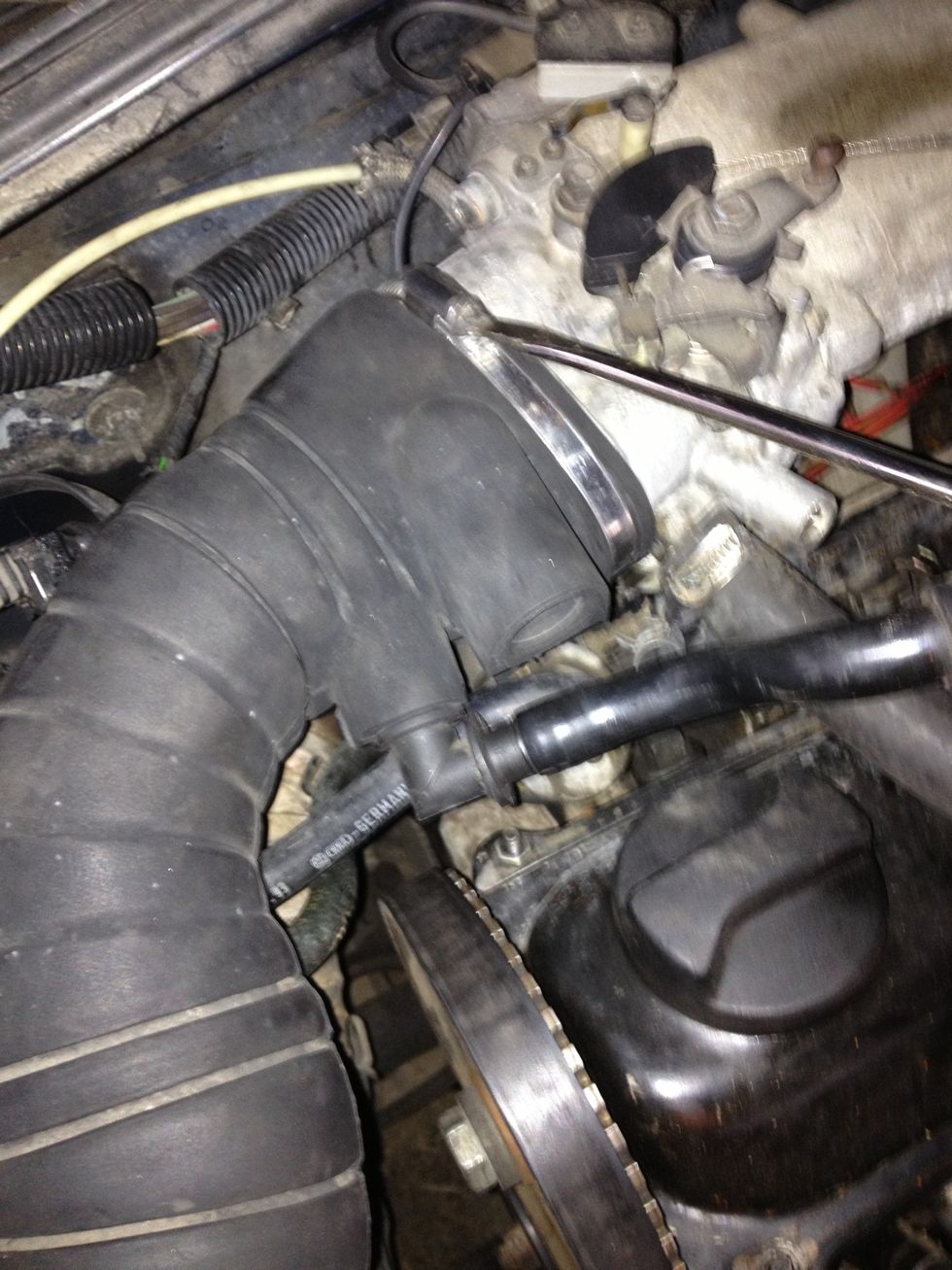 Loosen clamp on hose connected to throttle body.