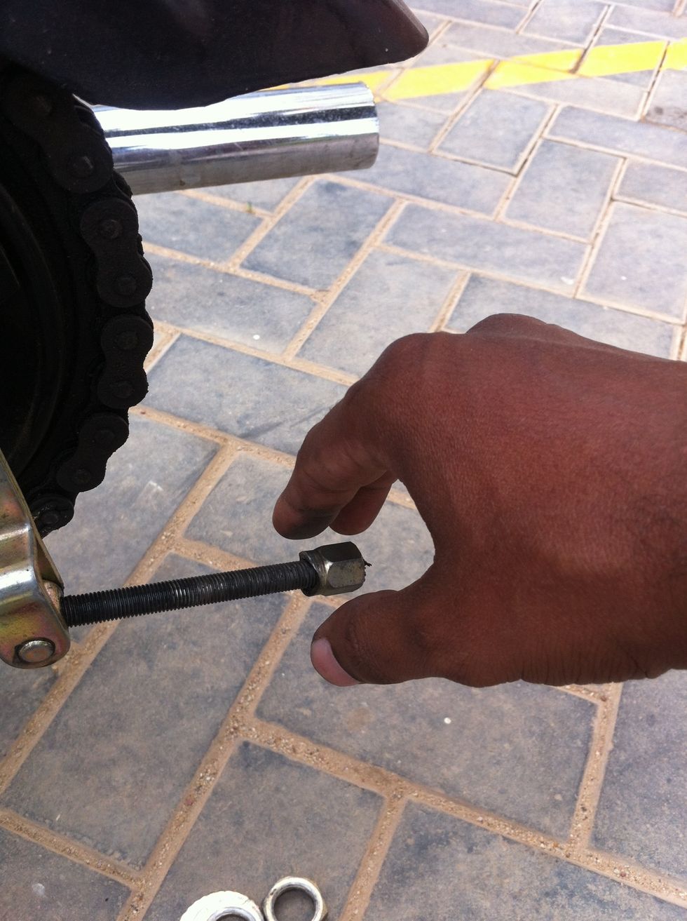 Loosen it and remove it by hand