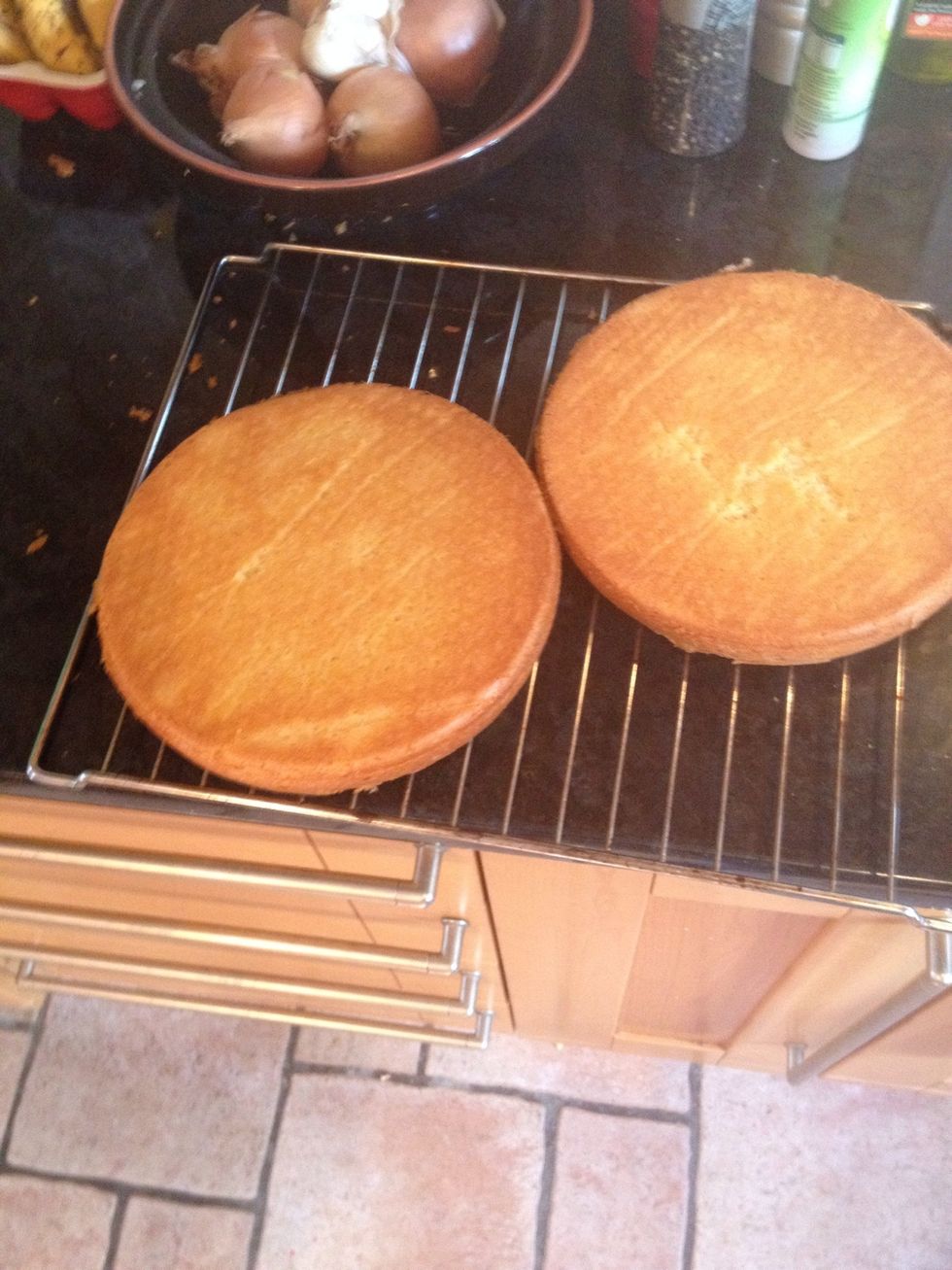 Loosen sponges with a knife around the edge. Flip over and leave on a wire rack to cool fully.