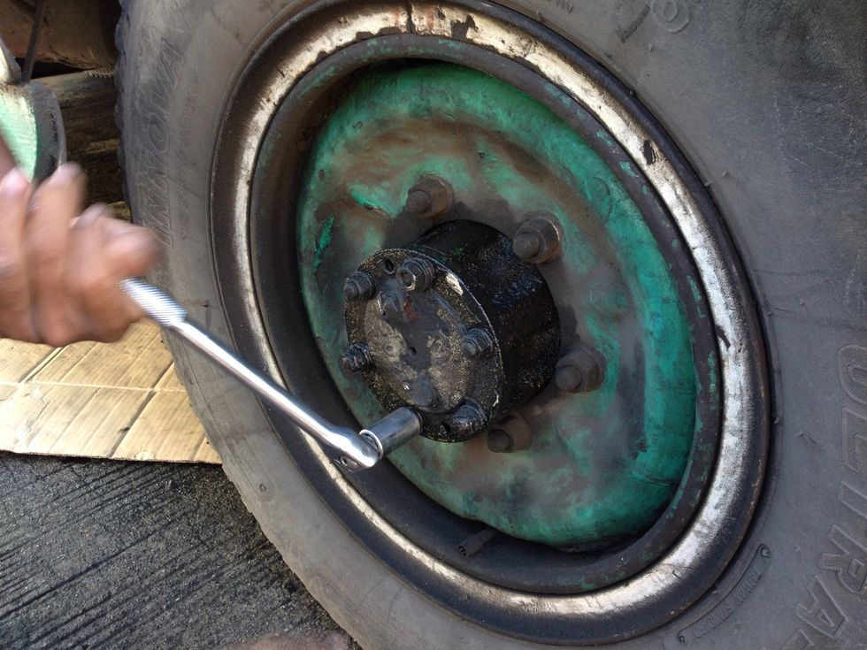 Loosen the (6) 12 mm size nuts as shown.