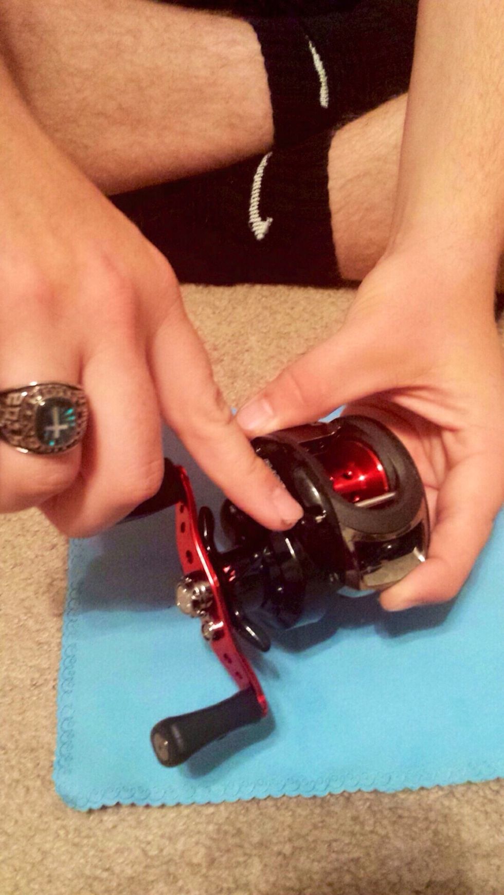 Loosen the knob to free the horizontal silver pin.