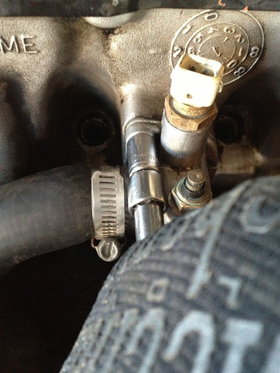 Loosen the top bolt mounting the coolant temperature sensor housing to cylinder head... - 10mm Socket