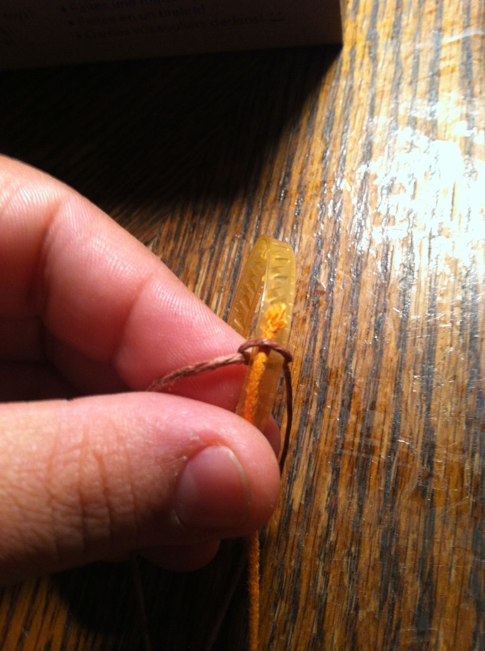 Loosen your knot a little on the outside of your ring and slide the end of your second color in. Then retighten.