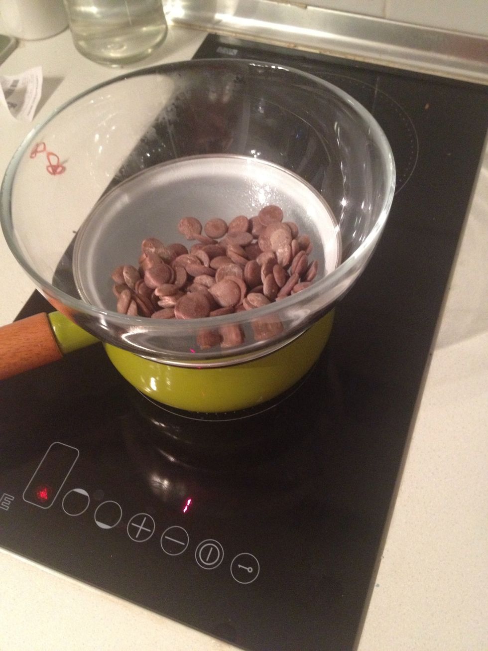Low the heat when the water reach simmer ing point and put the chocolate bowl on top of the pot make sure the water doesn't touch the bottom of the bowl.