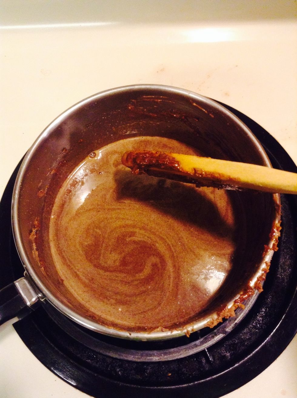 Lower burner, and add sugar and hot cocoa mix. Mix until blended. Add half a cup of the milk and mix until it is pretty much liquified.