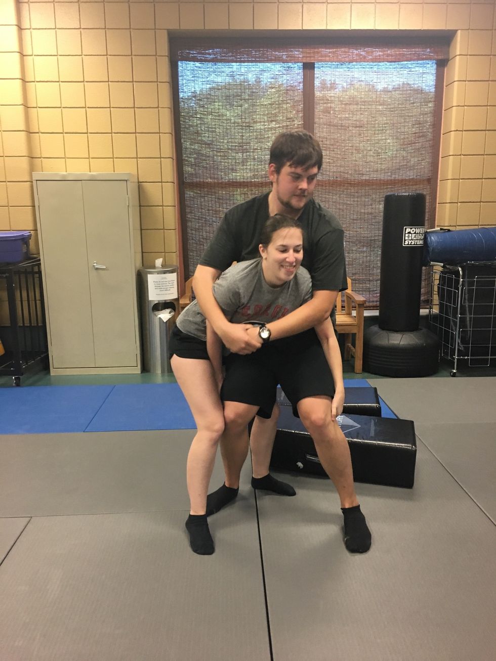 Lower hips and reach behind the attacker's knees.