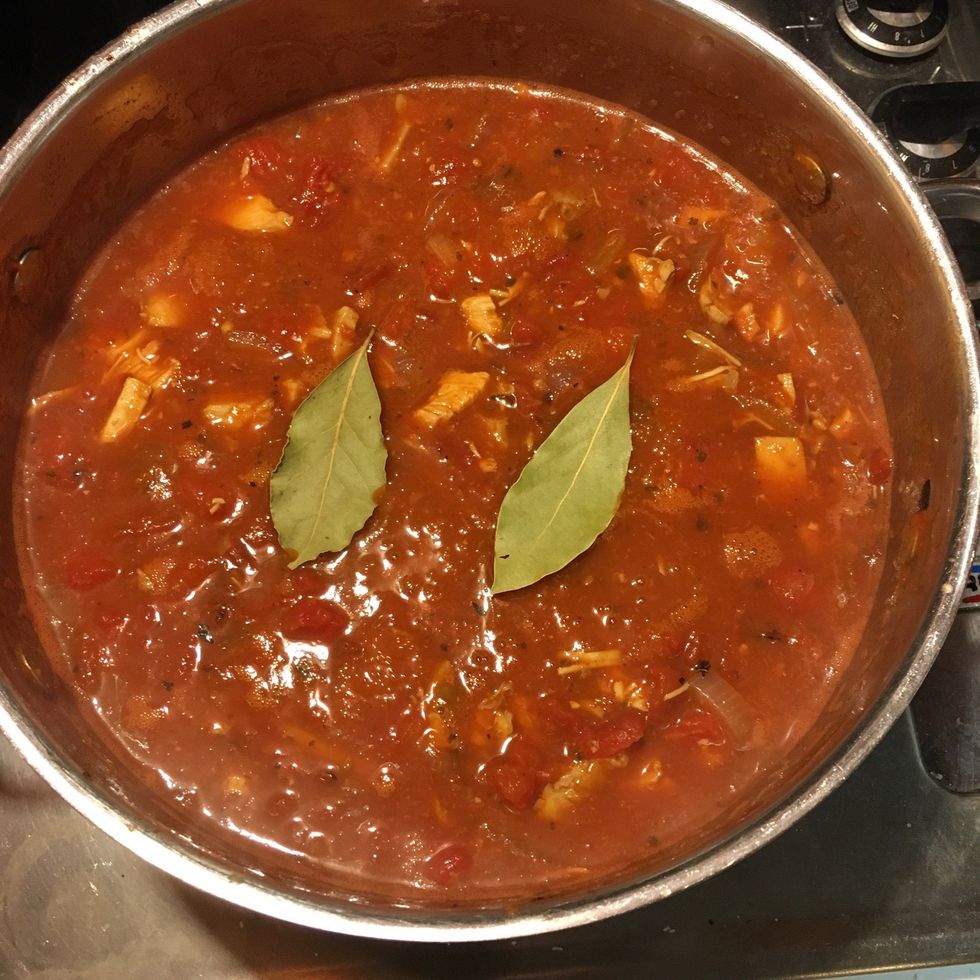 Lower the heat and add the bay leaves. You can spoon soup over them or just dip them in. Try not to break them, makes them harder to remove when your done. Let it simmer for at least one hour.