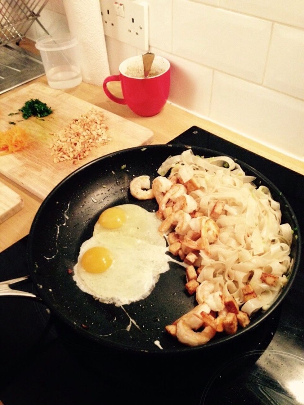Lower the heat and crack the two eggs.