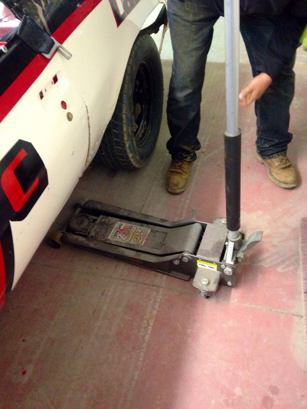 Lower the jack to place car back on the ground.