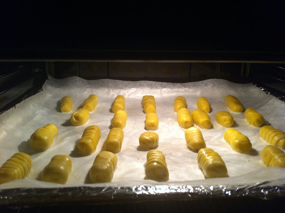 Lower the oven temperature to 180 \u00baC (350 \u00baF) and bake them until they are golden brown, ie, approximately 30 minutes