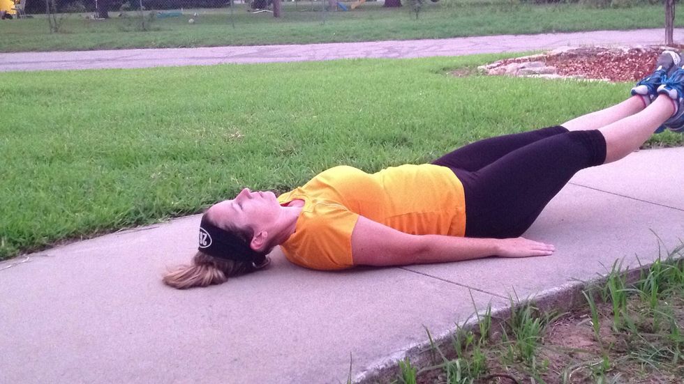 Lower your legs towards the ground. Keep your back flat on ground and pull your abs in tight.
