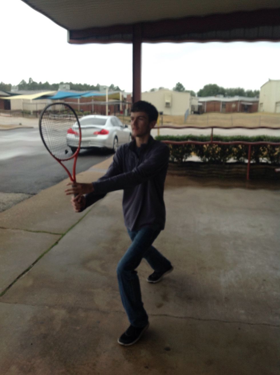 Lung towards the ball with your racquet out in front of your body