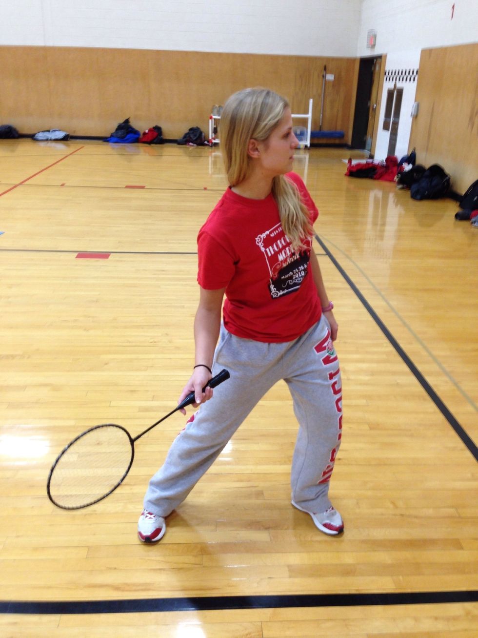 Lunge- reach with your dominant hand and foot, hole your racquet arm up, put your weight slightly on your front foot, and pivot and read in the direction on the shuttle.