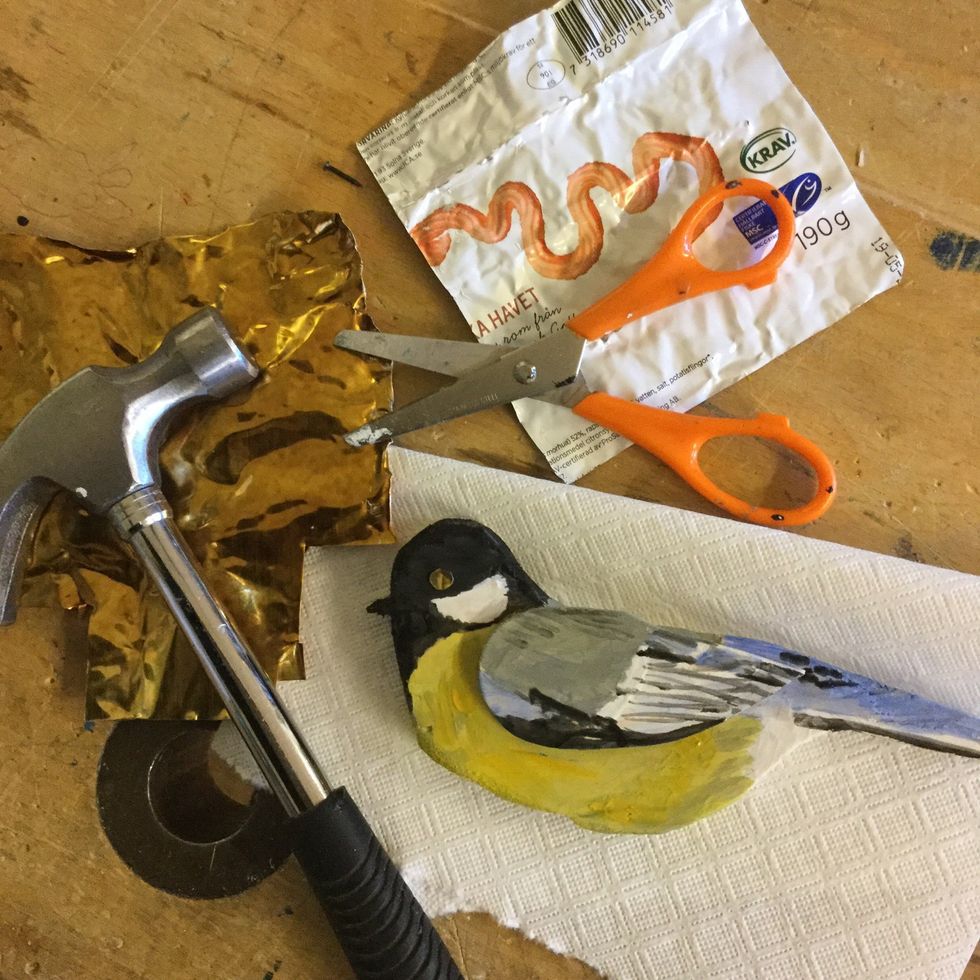 M\u00e5la f\u00e5geln i f\u00e4rg. Om du vill kan du ocks\u00e5 klippa ut en bit guldmetall fr\u00e5n en kaviartub, klipp en "prick" och spika fast som \u00f6ga.