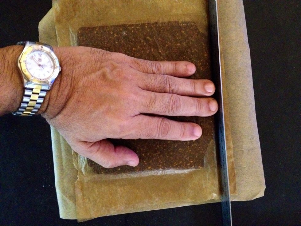 Maintain a straight edge so that cutting into squares is easier. I do this by using a stainless steel ruler pressed into the edges while my other hand evens out the top surface to flatten.