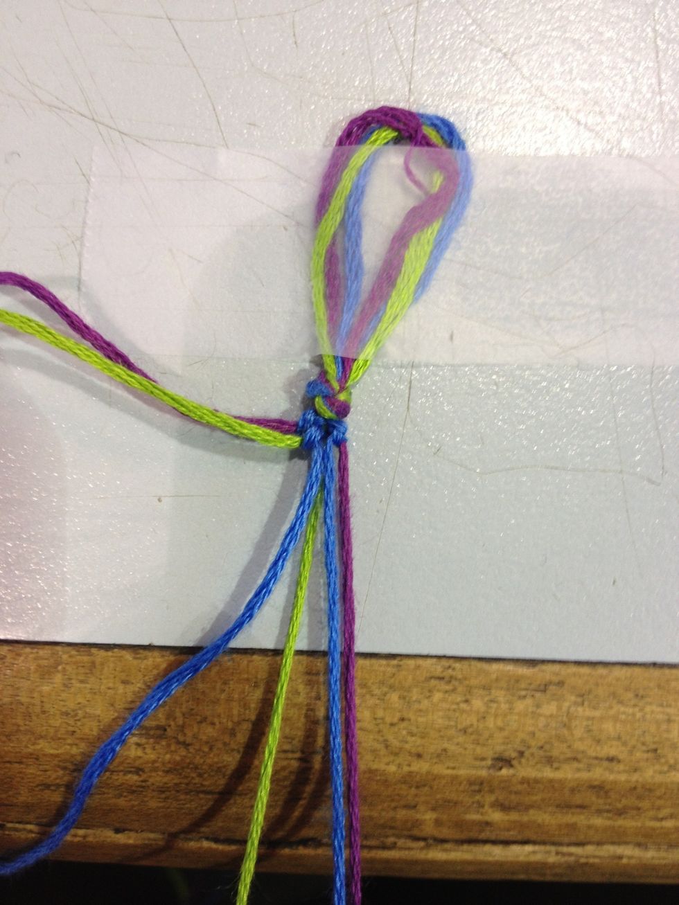 Make 2 knots just like before! Now move on to the next string so for me I'd put the purple aside and move on to the green.