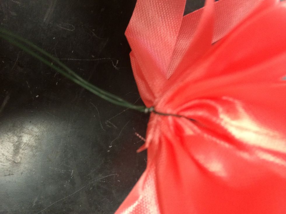 make 3-4 loops on both sides. after you have made all the loops tie a piece of wire around the center of the ribbon where you were pinching it to secure the bow.