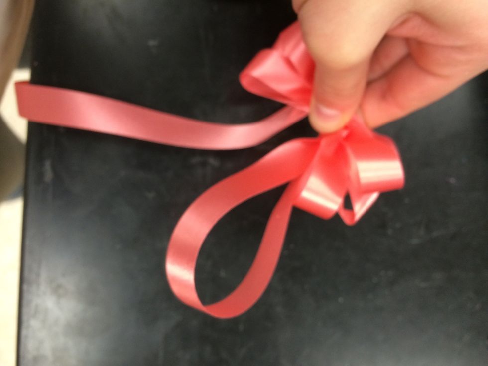 make 3-4 loops on both sides of the bow. after you have made all of your loops you have to make one big loop which you will cut later for the tails.