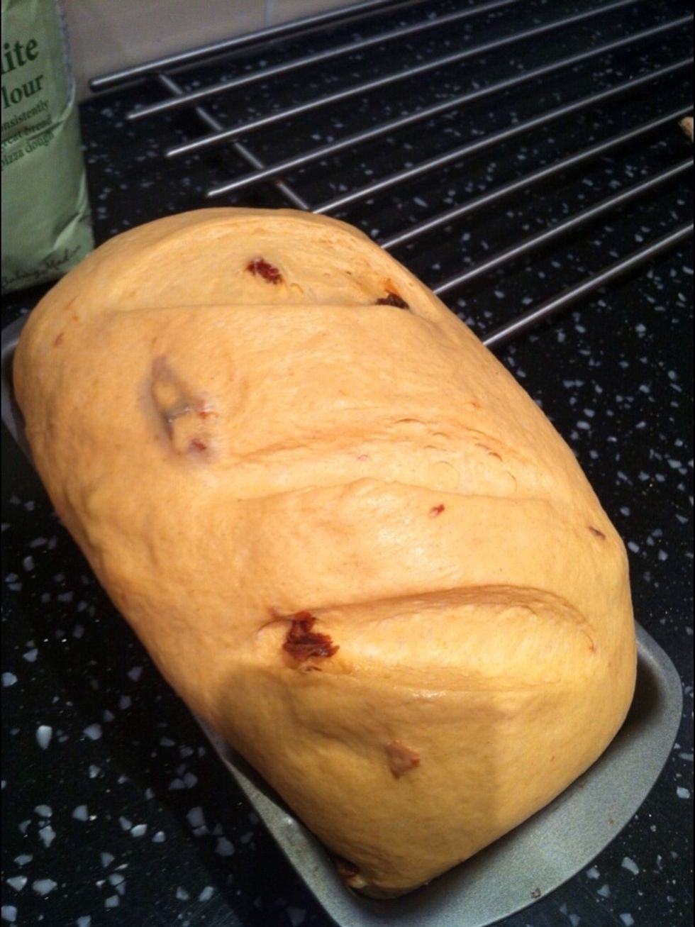Make 3 small diagonal slices on the top of the dough with a sharp knife. This will allow the dough to rise properly in the oven