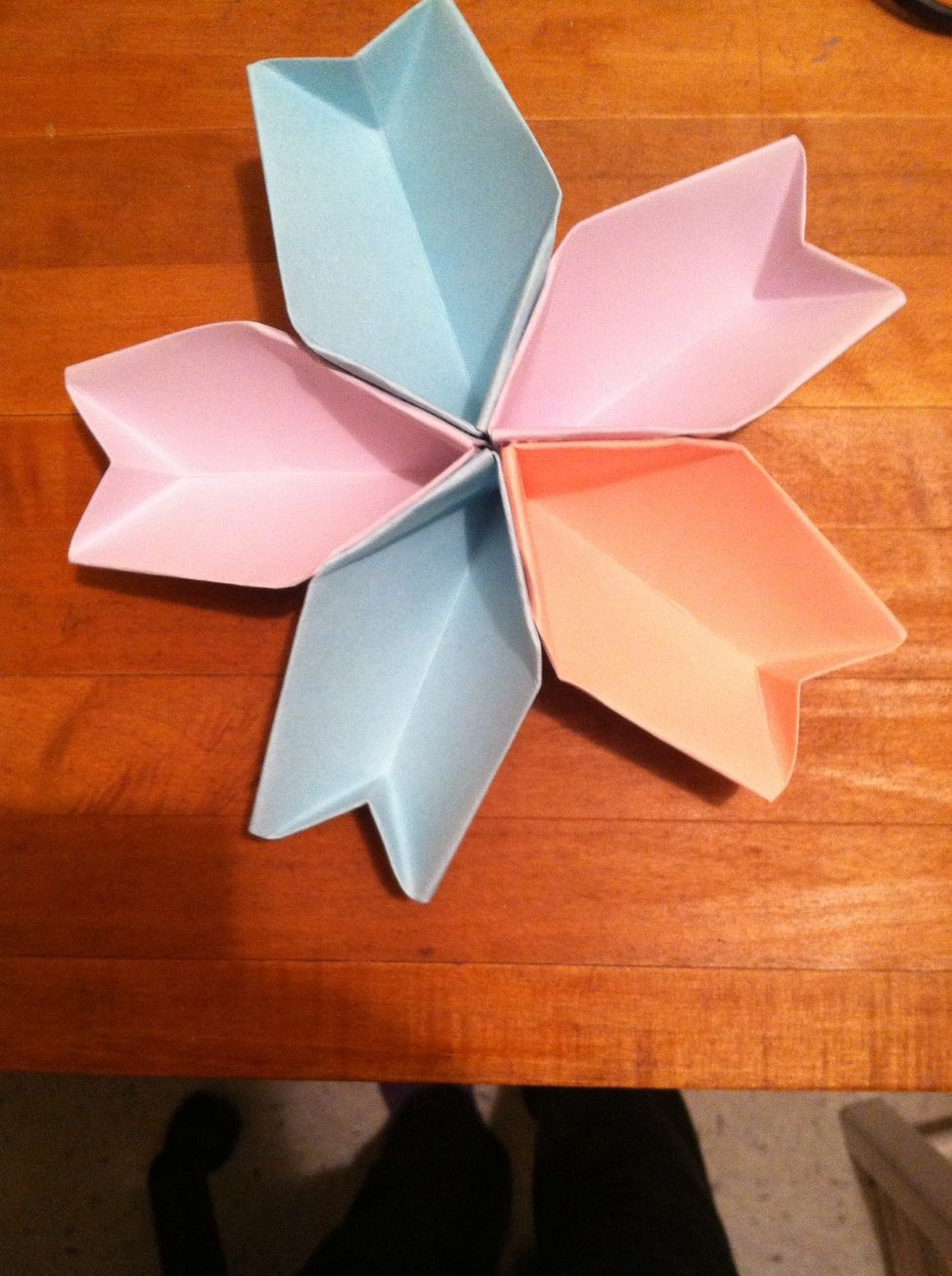 Make 4 more, then put glue on the whole slanted side and hold it together with the one next to it to glue them together.