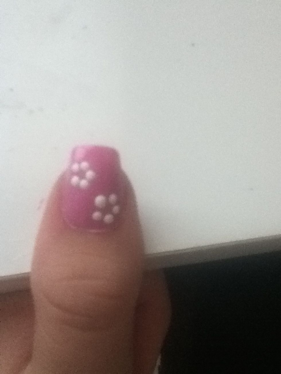 Make 5 dots forming a flower shape. My finger looks fat because I'm pressing it on the table \ud83d\ude02 You can make the dots with a toothpick or dotting tool.