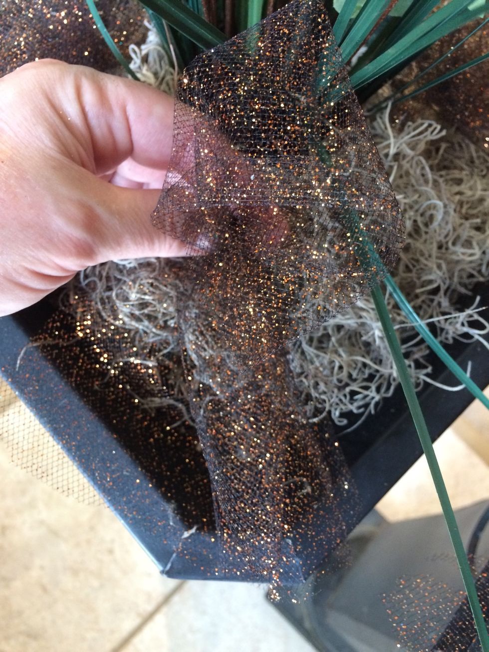 Make 8 bunches, then poke each  into the planter around the base of the arrangement. Thick wire will poke into the soil. Thin wire will still secure the bow in the moss.