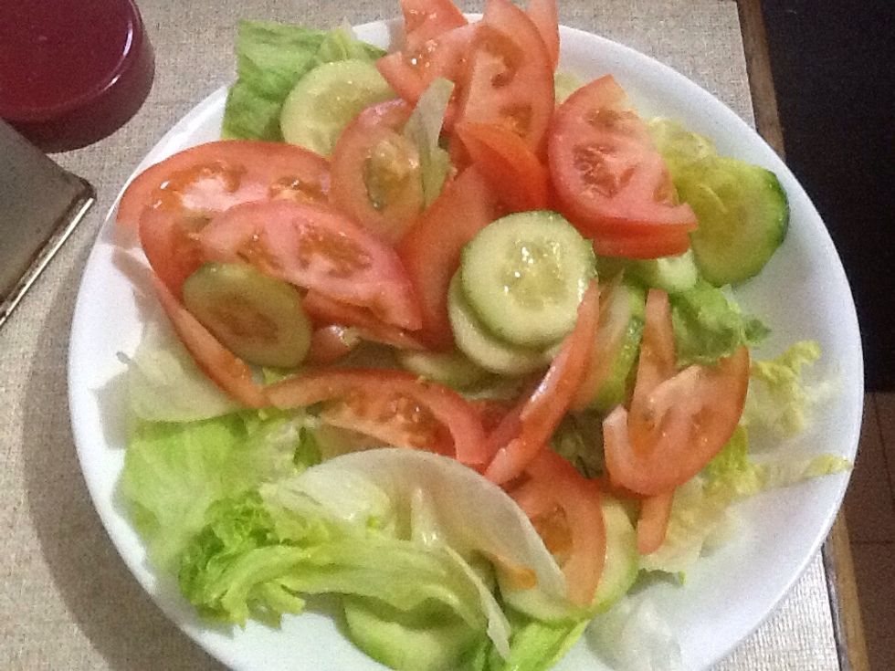 Make a basic salad out of lettuce, tomato and cucumber