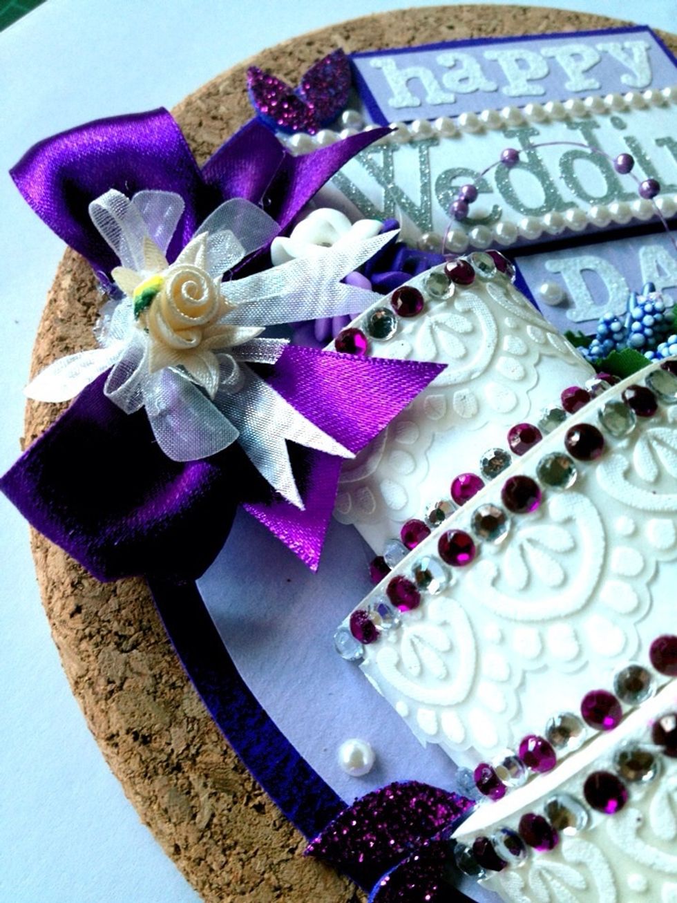 Make a bow using ribbon and stick on it.